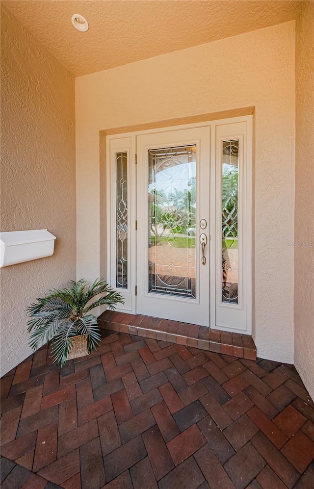 671 Tallahassee Dr NE, Saint Petersburg, FL 33702 - entrance to property with stucco siding and french doors