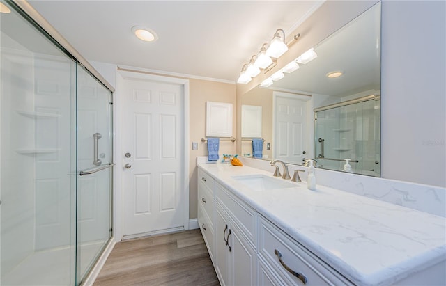 671 Tallahassee Dr NE, Saint Petersburg, FL 33702 - full bathroom with a shower stall, wood finished floors, vanity, and recessed lighting