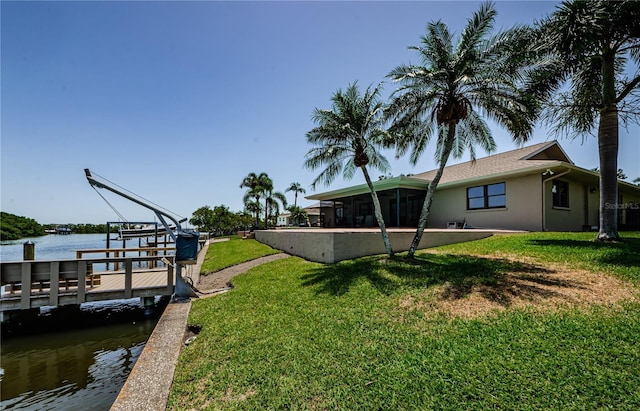 671 Tallahassee Dr NE, Saint Petersburg, FL 33702 - view of green lawn featuring a water view and a dock