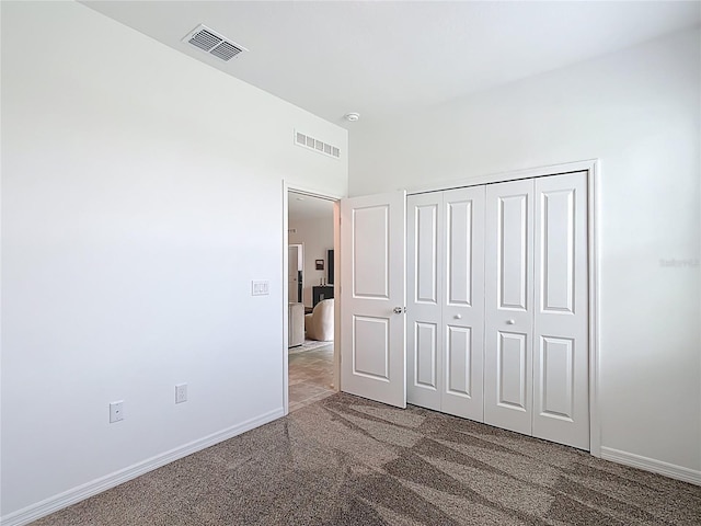 800 Reggie Rd, Winter Haven, FL 33884 - unfurnished bedroom featuring carpet floors, baseboards, and a closet