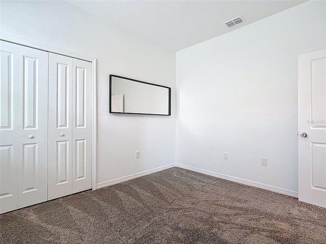 800 Reggie Rd, Winter Haven, FL 33884 - unfurnished bedroom with carpet floors, a closet, and baseboards