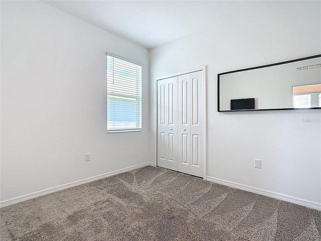 800 Reggie Rd, Winter Haven, FL 33884 - unfurnished bedroom featuring carpet floors, baseboards, and a closet