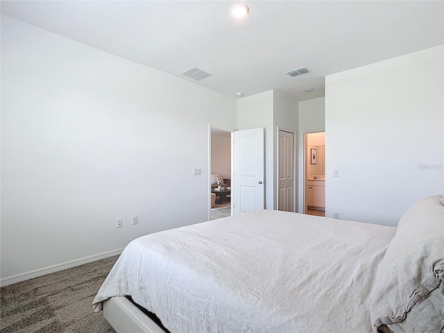 800 Reggie Rd, Winter Haven, FL 33884 - carpeted bedroom with baseboards and ensuite bathroom