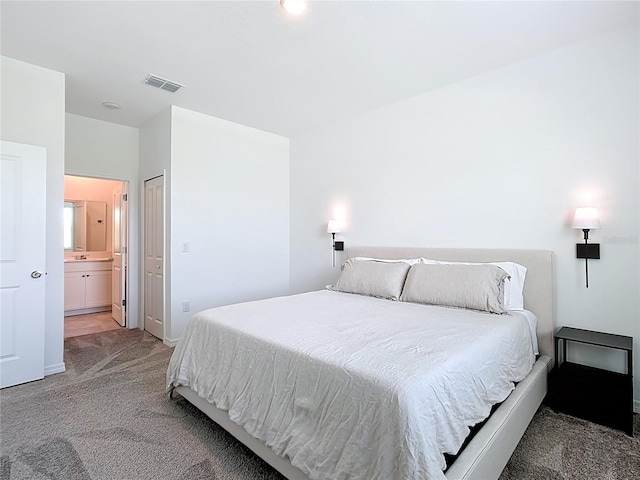 800 Reggie Rd, Winter Haven, FL 33884 - bedroom featuring light colored carpet, ensuite bath, and baseboards
