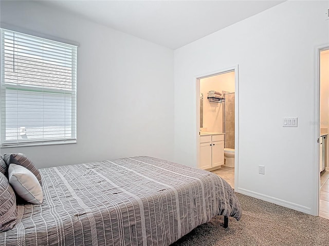 800 Reggie Rd, Winter Haven, FL 33884 - bedroom featuring light colored carpet, connected bathroom, and baseboards