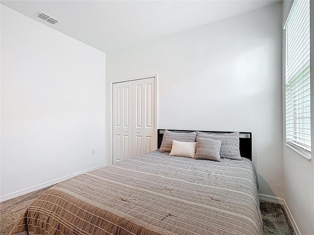 800 Reggie Rd, Winter Haven, FL 33884 - bedroom with carpet floors, a closet, and baseboards