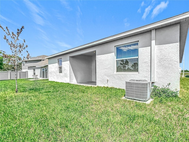 800 Reggie Rd, Winter Haven, FL 33884 - rear view of house with central AC and stucco siding