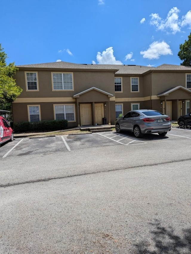 5915 Brickleberry Ln Unit 103, Zephyrhills, FL 33541 - view of front of property featuring uncovered parking and stucco siding