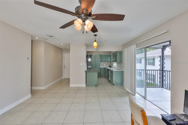 13125 Wilcox Rd Unit 16202, Largo, FL 33774 - kitchen with green cabinets, a ceiling fan, a textured ceiling, light tile patterned floors, and a sink