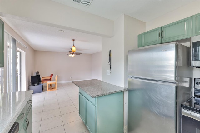 13125 Wilcox Rd Unit 16202, Largo, FL 33774 - kitchen with appliances with stainless steel finishes, ceiling fan, green cabinetry, light tile patterned flooring, and light stone countertops
