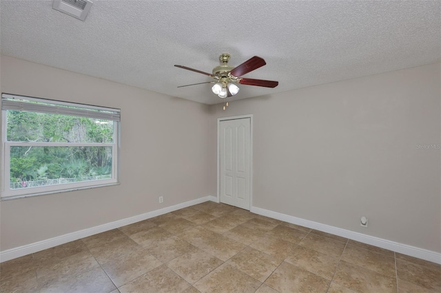 13125 Wilcox Rd Unit 16202, Largo, FL 33774 - spare room featuring a ceiling fan, baseboards, a textured ceiling, and light tile patterned flooring