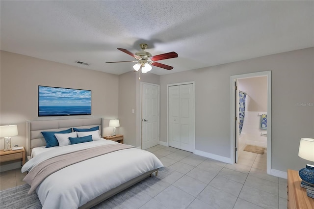13125 Wilcox Rd Unit 16202, Largo, FL 33774 - bedroom with light tile patterned floors, baseboards, ceiling fan, ensuite bathroom, and a closet
