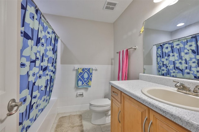 13125 Wilcox Rd Unit 16202, Largo, FL 33774 - bathroom with vanity, tile walls, tile patterned flooring, toilet, and shower / bath combo