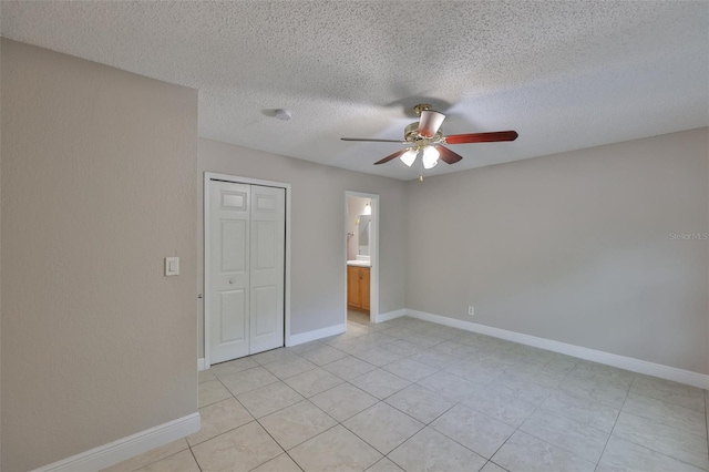 13125 Wilcox Rd Unit 16202, Largo, FL 33774 - unfurnished bedroom featuring light tile patterned floors, baseboards, a textured ceiling, a ceiling fan, and a closet