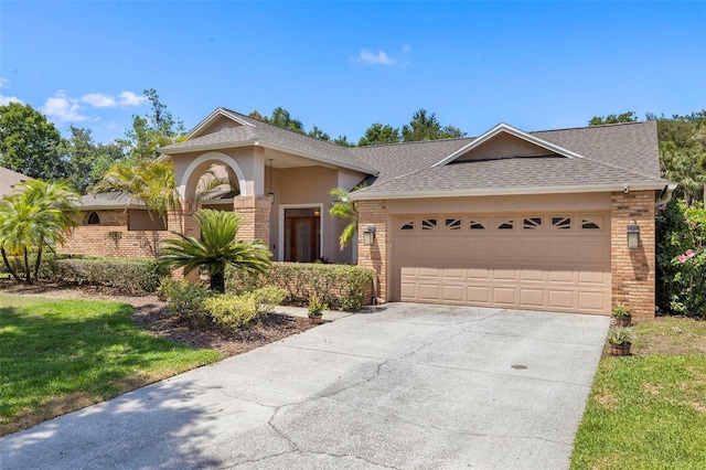 3922 Cedar Cay Cir, Valrico, FL 33596 - view of front of property with brick siding, concrete driveway, a shingled roof, an attached garage, and stucco siding