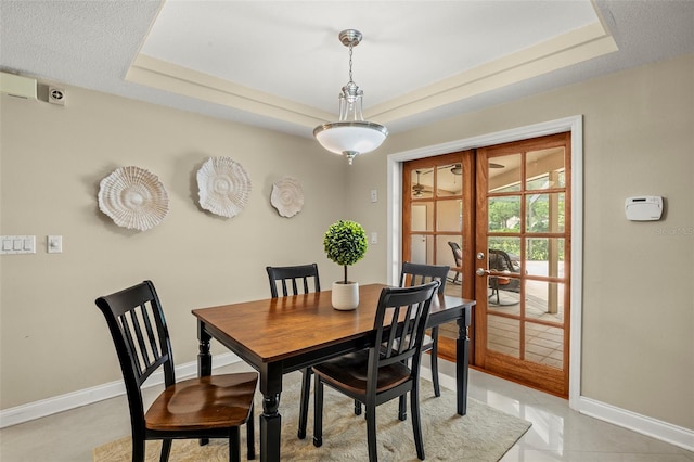 3922 Cedar Cay Cir, Valrico, FL 33596 - dining space with a raised ceiling, french doors, baseboards, and light tile patterned flooring