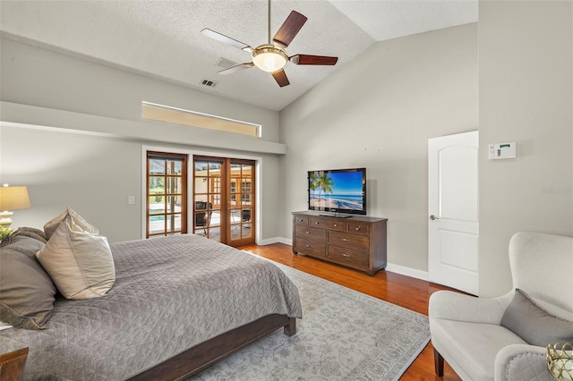 3922 Cedar Cay Cir, Valrico, FL 33596 - bedroom with wood finished floors, french doors, baseboards, high vaulted ceiling, and a ceiling fan