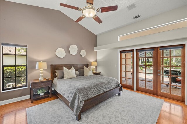 3922 Cedar Cay Cir, Valrico, FL 33596 - bedroom featuring access to exterior, french doors, high vaulted ceiling, light wood-style floors, and multiple windows