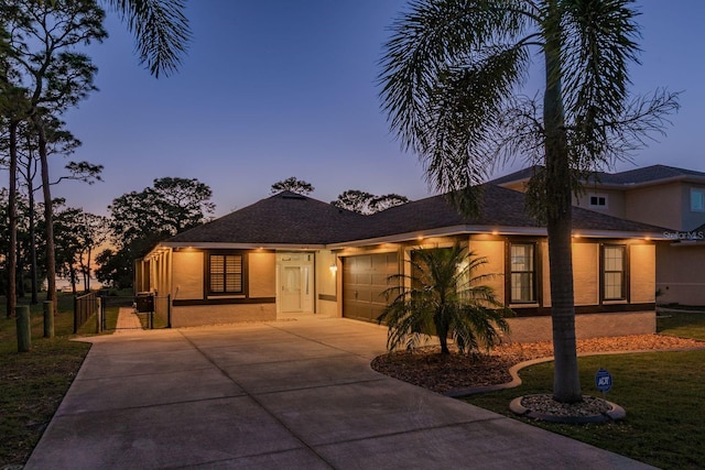 632 S Florida Ave, Tarpon Springs, FL 34689 - single story home with concrete driveway, stucco siding, an attached garage, a front yard, and a gate
