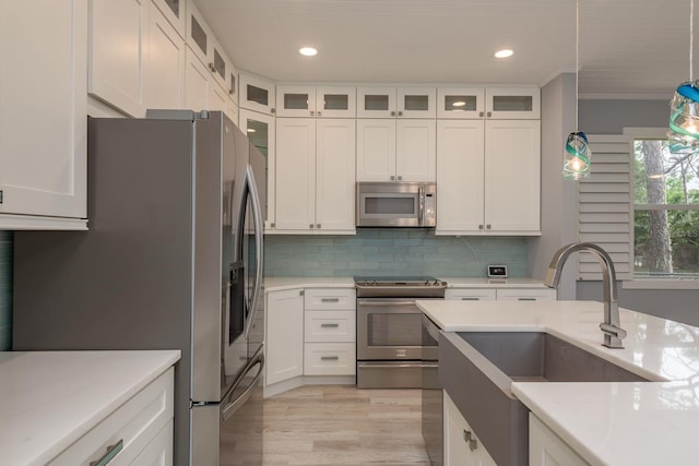 632 S Florida Ave, Tarpon Springs, FL 34689 - kitchen with appliances with stainless steel finishes, white cabinetry, recessed lighting, and ornamental molding