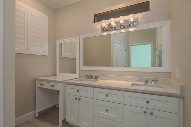 632 S Florida Ave, Tarpon Springs, FL 34689 - bathroom featuring ornamental molding, double vanity, wood finished floors, and baseboards