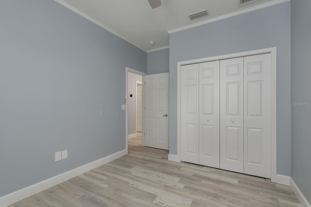 632 S Florida Ave, Tarpon Springs, FL 34689 - unfurnished bedroom featuring ornamental molding, light wood-style flooring, baseboards, a closet, and ceiling fan