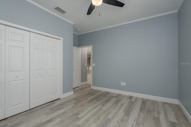 632 S Florida Ave, Tarpon Springs, FL 34689 - unfurnished bedroom featuring light wood-type flooring, crown molding, a closet, baseboards, and ceiling fan