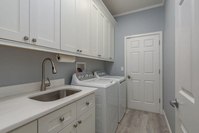 632 S Florida Ave, Tarpon Springs, FL 34689 - laundry room with cabinet space, washing machine and clothes dryer, crown molding, and light wood-type flooring