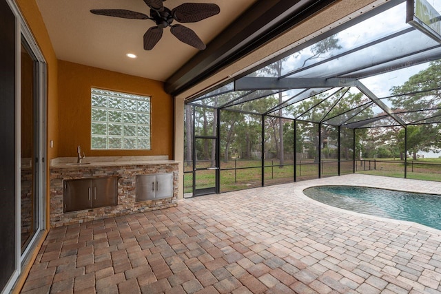 632 S Florida Ave, Tarpon Springs, FL 34689 - swimming pool with an outdoor kitchen, a patio area, a lanai, and ceiling fan
