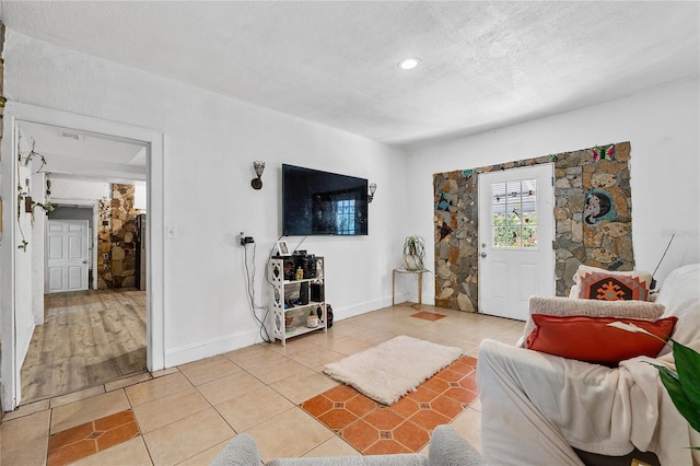 536 Ave G SE, Winter Haven, FL 33880 - living area with light tile patterned floors, a textured ceiling, baseboards, and recessed lighting