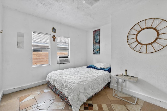 536 Ave G SE, Winter Haven, FL 33880 - bedroom with light tile patterned floors, baseboards, a textured ceiling, and cooling unit