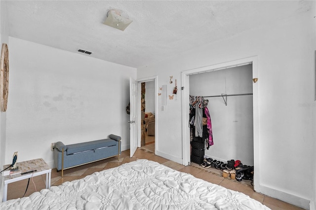 536 Ave G SE, Winter Haven, FL 33880 - bedroom with a closet, baseboards, and tile patterned floors