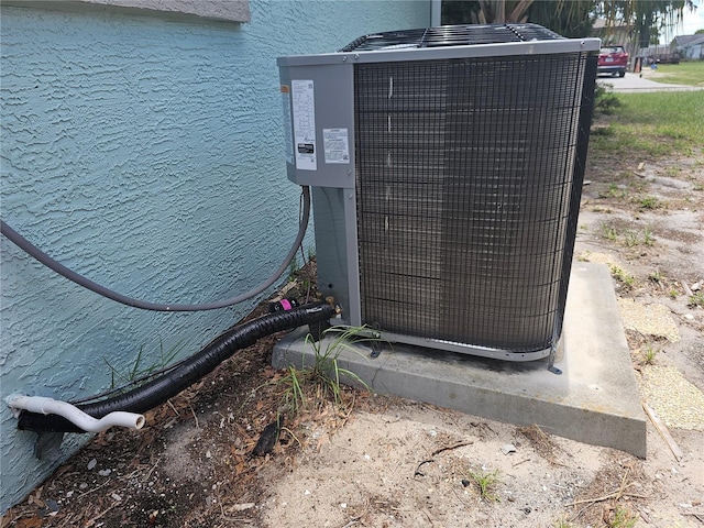 exterior view of cooling unit and stucco siding