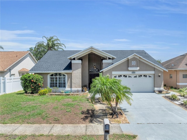 332 Wood Dove Ave, Tarpon Springs, FL 34689 - view of front of home featuring stucco siding, a garage, concrete driveway, and a shingled roof
