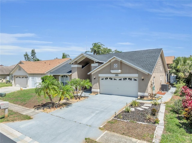 332 Wood Dove Ave, Tarpon Springs, FL 34689 - view of front of property featuring stucco siding, an attached garage, central air condition unit, concrete driveway, and a shingled roof