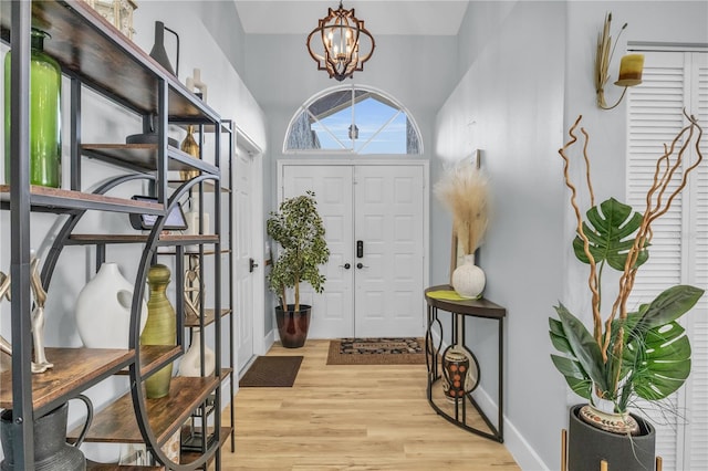 332 Wood Dove Ave, Tarpon Springs, FL 34689 - entryway featuring light wood-type flooring, baseboards, and a chandelier