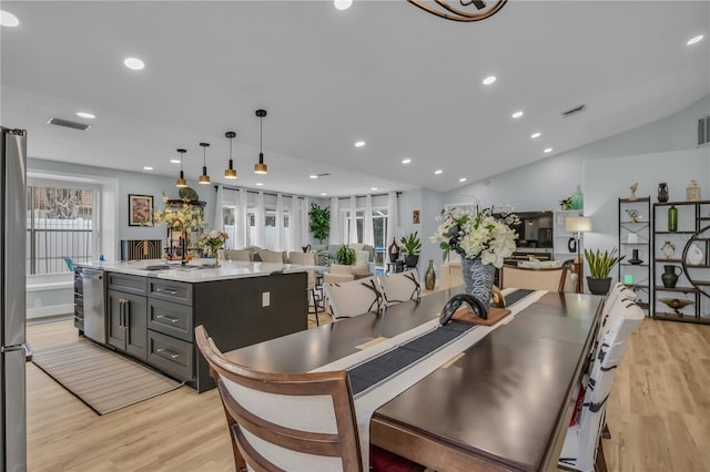 332 Wood Dove Ave, Tarpon Springs, FL 34689 - kitchen with light wood finished floors, an island with sink, light countertops, recessed lighting, and decorative light fixtures