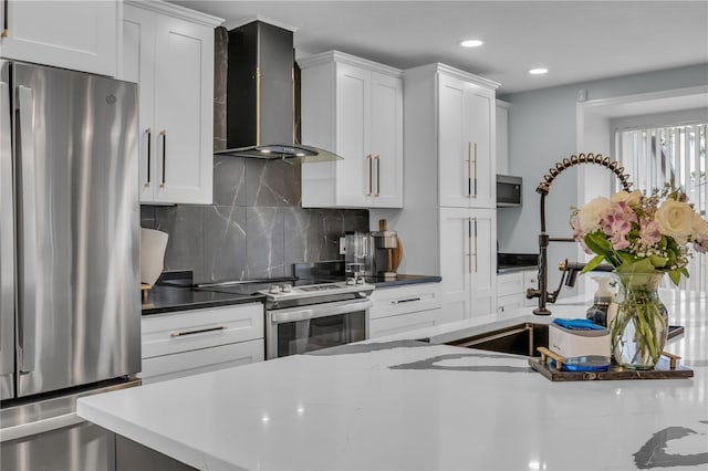 332 Wood Dove Ave, Tarpon Springs, FL 34689 - kitchen featuring appliances with stainless steel finishes, wall chimney range hood, backsplash, recessed lighting, and white cabinetry