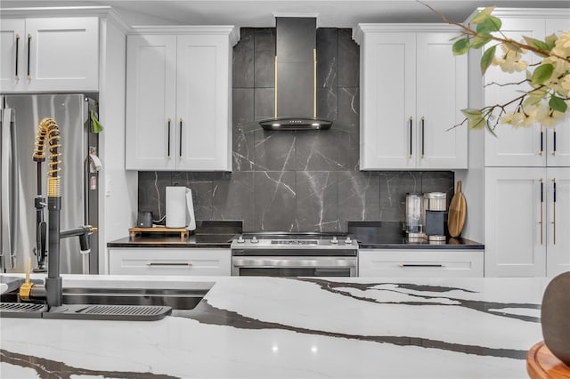 332 Wood Dove Ave, Tarpon Springs, FL 34689 - kitchen featuring appliances with stainless steel finishes, wall chimney exhaust hood, white cabinets, dark stone counters, and backsplash