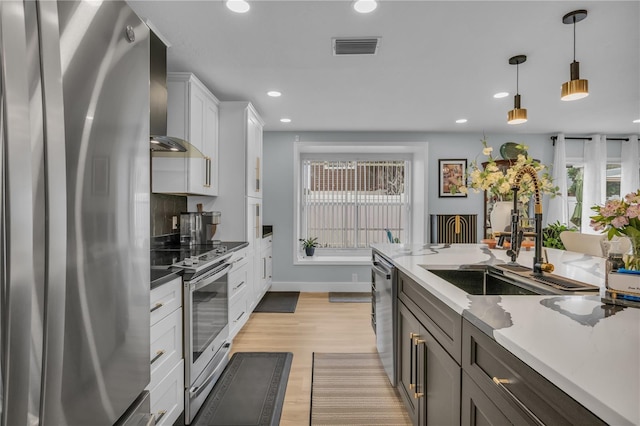 332 Wood Dove Ave, Tarpon Springs, FL 34689 - kitchen featuring appliances with stainless steel finishes, a sink, wall chimney exhaust hood, plenty of natural light, and recessed lighting