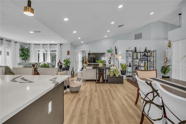332 Wood Dove Ave, Tarpon Springs, FL 34689 - kitchen with vaulted ceiling, light wood-style flooring, open floor plan, recessed lighting, and light countertops