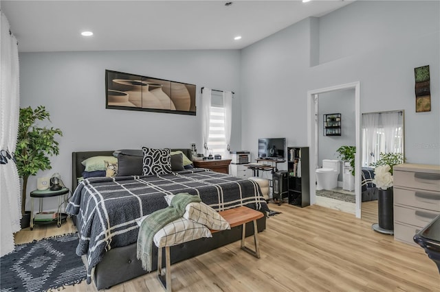 332 Wood Dove Ave, Tarpon Springs, FL 34689 - bedroom with light wood finished floors, high vaulted ceiling, recessed lighting, and ensuite bath