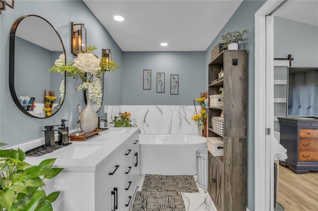 332 Wood Dove Ave, Tarpon Springs, FL 34689 - full bathroom with double vanity, a soaking tub, and recessed lighting
