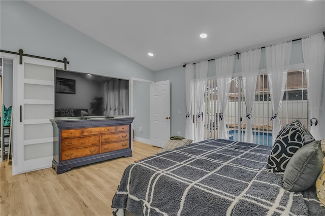 332 Wood Dove Ave, Tarpon Springs, FL 34689 - bedroom with light wood finished floors, lofted ceiling, a barn door, recessed lighting, and baseboards