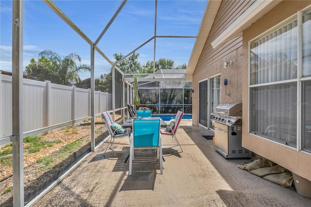 332 Wood Dove Ave, Tarpon Springs, FL 34689 - view of patio / terrace with grilling area, a fenced backyard, and glass enclosure