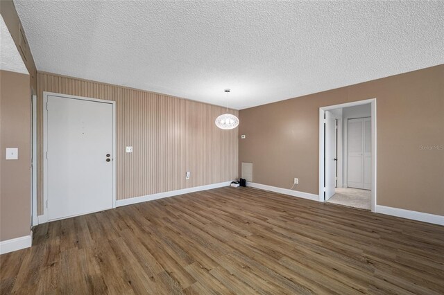 10216 Regal Dr Unit 208, Largo, FL 33774 - spare room with wood finished floors, a textured ceiling, and baseboards