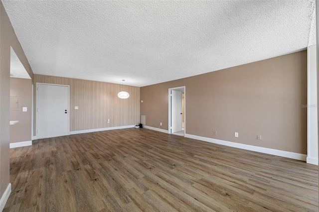 10216 Regal Dr Unit 208, Largo, FL 33774 - unfurnished room featuring baseboards, wood finished floors, and a textured ceiling