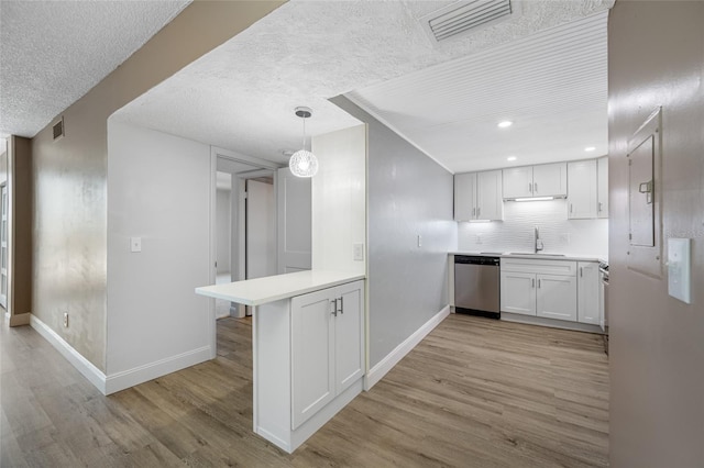10216 Regal Dr Unit 208, Largo, FL 33774 - kitchen featuring dishwasher, light wood-type flooring, baseboards, a textured ceiling, and recessed lighting