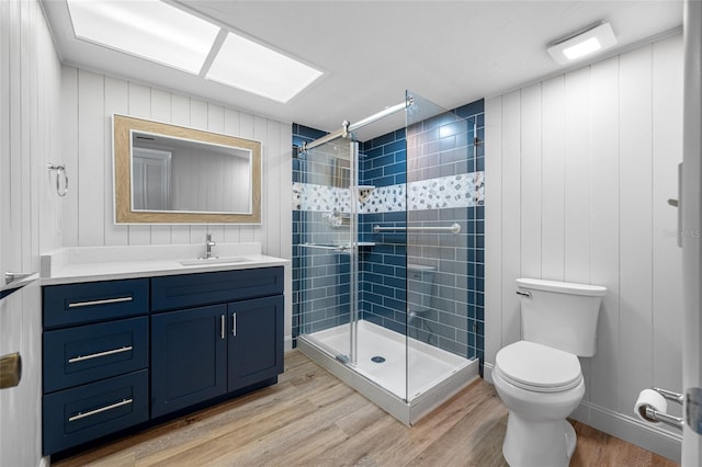 10216 Regal Dr Unit 208, Largo, FL 33774 - bathroom with wood finished floors, a shower stall, toilet, and vanity
