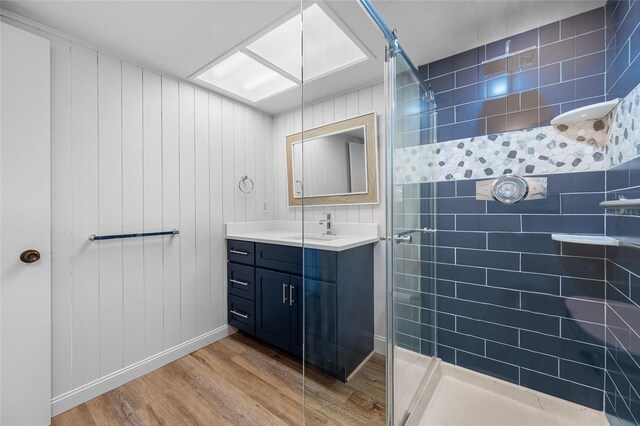 10216 Regal Dr Unit 208, Largo, FL 33774 - bathroom featuring wood finished floors, tiled shower, vanity, and baseboards